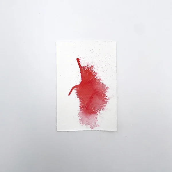 Prøve på skarlagen rød tegneblæk på akvarelpapir med gradient- og spredeeffekt.