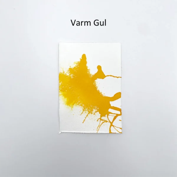 Farveprøve med varm gul tusch på akvarelpapir med abstrakt stænk-effekt.